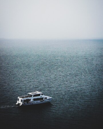 mesmerizing-view-boat-calm-sea-foggy-day_181624-28608