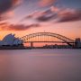 beautiful-shot-sydney-harbor-bridge-with-light-pink-blue-sky_181624-16041